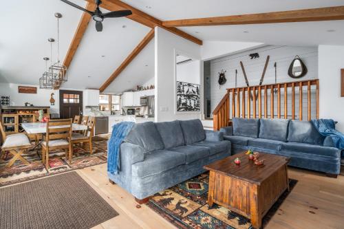 a living room with two blue couches and a table at Catskills Mountain Retreat - Luxury Meets Serenity in Jewett