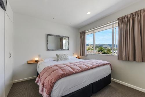 a bedroom with a large bed and a window at Boutique Motel in Nelson