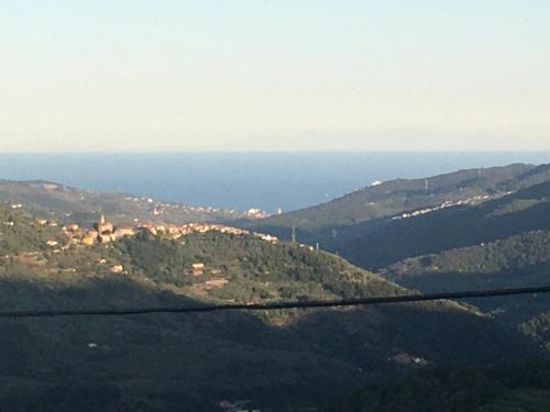 a view of a mountain with the ocean in the background at Bella Casa Cantoniera in Caravonica