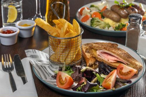 a plate of food with a sandwich and french fries at Best Western Sheffield City Hotel in Sheffield
