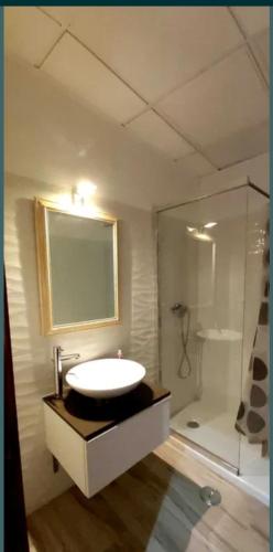 a bathroom with a sink and a shower at Casa da Corte in Minas de São Domingos