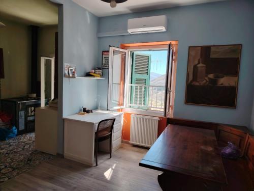 a living room with a table and a window at La casa colorata con vista in Borgomaro