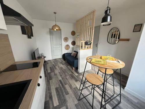 une cuisine et un salon avec une table et un canapé dans l'établissement les 1001 Briques, à Saint-Quentin