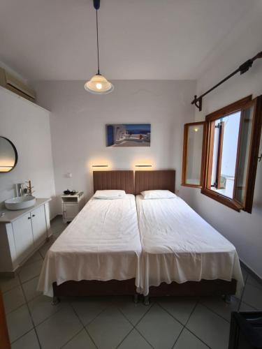 Ένα ή περισσότερα κρεβάτια σε δωμάτιο στο Maria Eleni Guesthouse