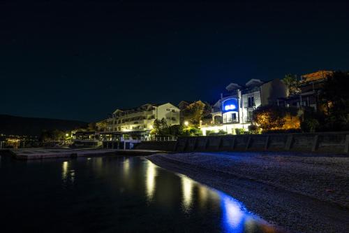 a view of a river at night with houses at Boka Bay Residences in Herceg-Novi