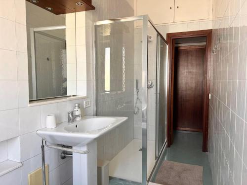 Un baño blanco con lavabo y ducha en From Sorrento with Love, en Sorrento