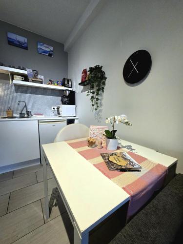 a kitchen with a table and a clock on the wall at Lucy's Apartment in Borgarnes