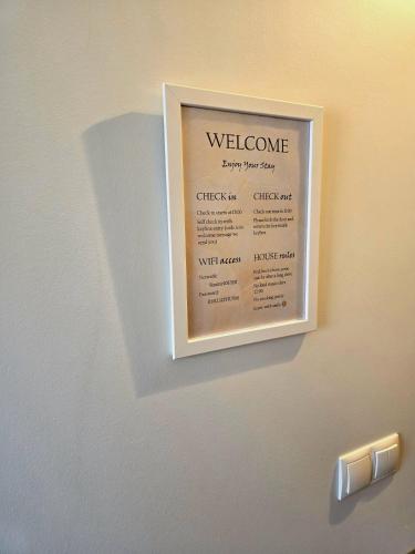 a welcome sign on the wall of a room at Lucy's Apartment in Borgarnes
