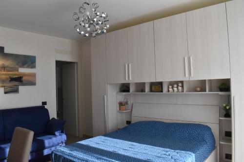 a bedroom with a blue bed and white cabinets at B&B Villa Paola in Savona