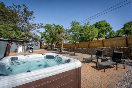 a hot tub in a yard with chairs and a fence at Old Town Stunner in Cottonwood
