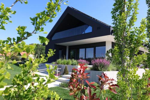 a modern house with a black roof at Smart & Wellness Villa in Ptuj