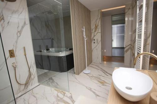 a bathroom with a sink and a tub and a toilet at Smart & Wellness Villa in Ptuj