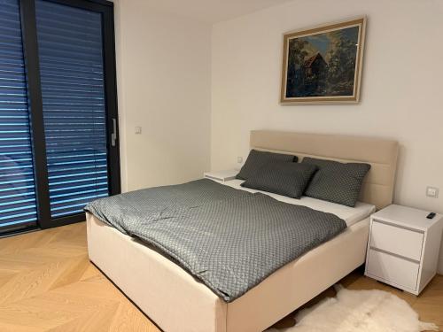 a bed in a bedroom with a picture on the wall at Smart & Wellness Villa in Ptuj