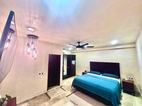 a bedroom with a bed and a ceiling fan at KASA in Tulum