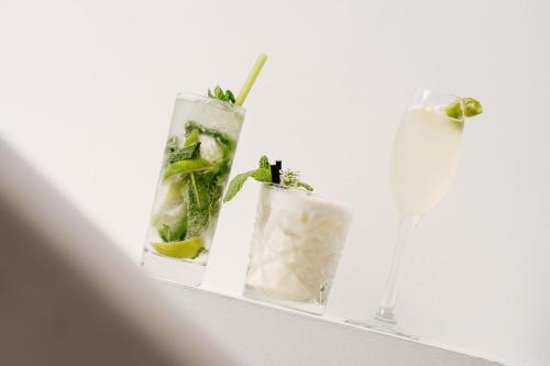 a shelf with two cocktails and a glass of wine at Pullman Auckland Hotel & Apartments in Auckland
