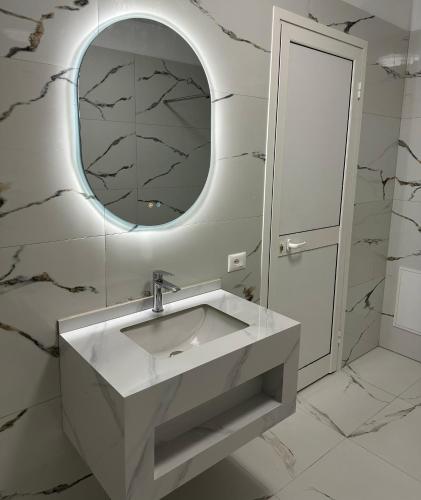a bathroom with a sink and a mirror at Rodon Blue Villa in Shetaj