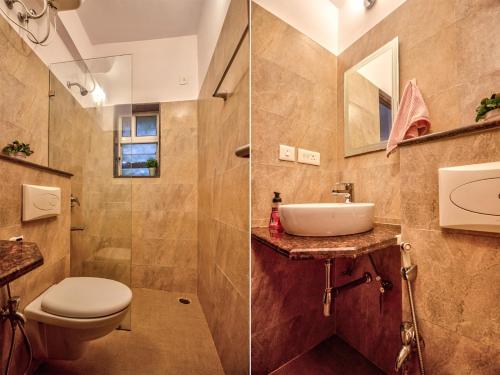 a bathroom with a toilet and a sink at Felix Homes 2 BHK With Pool Near Baga Beach in Arpora