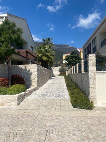 a stone path in front of a building at Apartman Celine PortoNovi in Kumbor