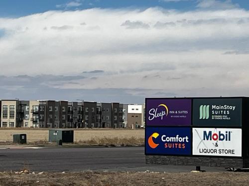 a sign on the side of a road in front of a building at Comfort Suites Denver International Airport in Denver