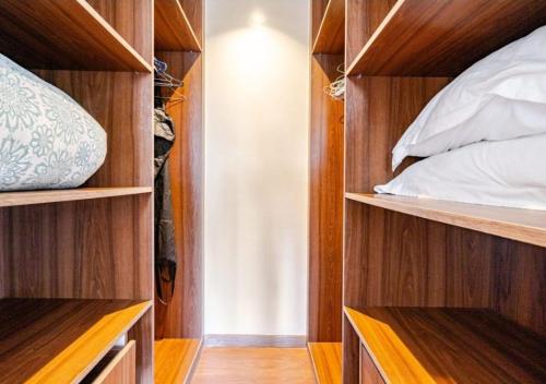a bedroom with wooden shelves and a bed in it at prestigieuse à casa finance city in Casablanca