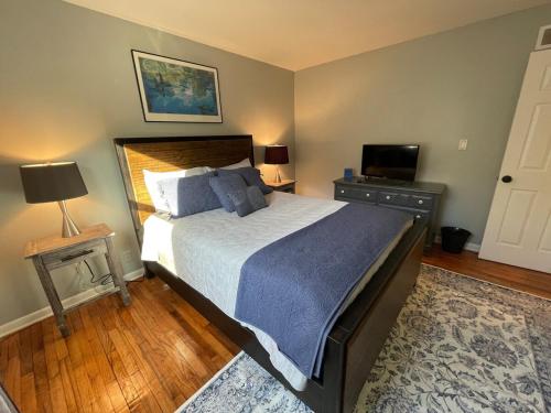 a bedroom with a large bed and a television at Sand Run Metro Park Getaway Home in Akron