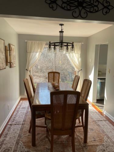 a dining room with a wooden table and chairs at Sand Run Metro Park Getaway Home in Akron