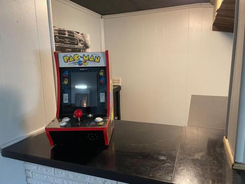 a red krispy kreme arcade game in a room at Sand Run Metro Park Getaway Home in Akron