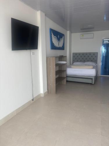 a room with a bed and a flat screen tv at habitacion con vista al mar in Cartagena de Indias