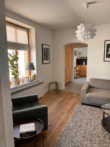 a living room with a couch and a chair at Apartament Tuchola in Tuchola