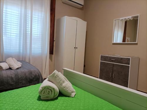 a bedroom with a bed and a dresser and a mirror at Villemar in Isola delle Femmine