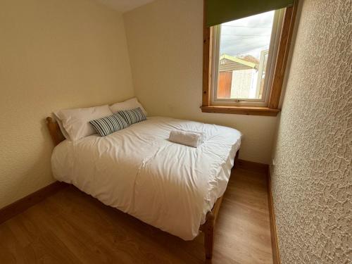 a small bed in a small room with a window at Mountain View House Kinlochleven in Kinlochleven