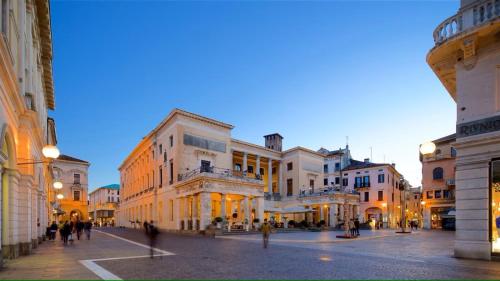 a group of buildings in a street at dusk at Officine Cavour CASA DEI LEONI Centro Storico Padova in Padova
