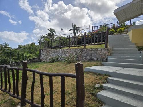 a set of stairs leading up to a building at Poinciana House in Montego Bay