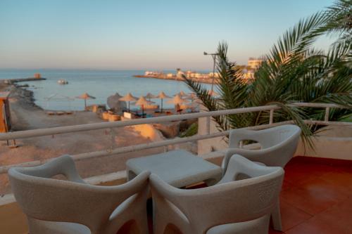 a balcony with chairs and a view of the ocean at Sea Life Apartments-hotel in Hurghada