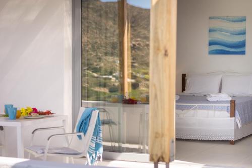 a bedroom with a bed and a window at Sarantis Suites & Apartments in Provatas