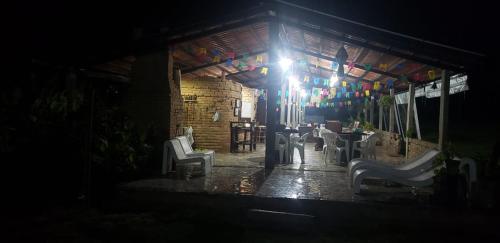 a room with a table and chairs in a building at FAZENDA BOSQUE DAs PALMEIRAS in Itamaracá