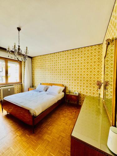 a bedroom with a bed and a glass shower at Nido tra monti in Sondrio