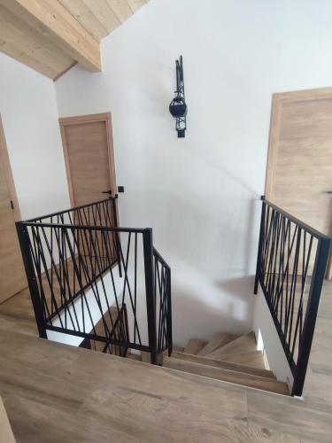 a staircase in a building with a chandelier at Chalet NEUF Jacuzzi Terrasse Salle jeux proche Font Romeu in Égat