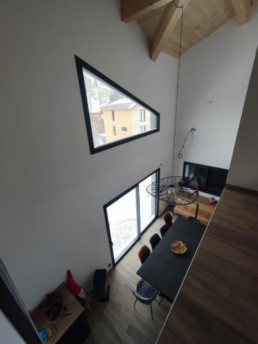 an overhead view of a living room with a table and chairs at Chalet NEUF Jacuzzi Terrasse Salle jeux proche Font Romeu in Égat