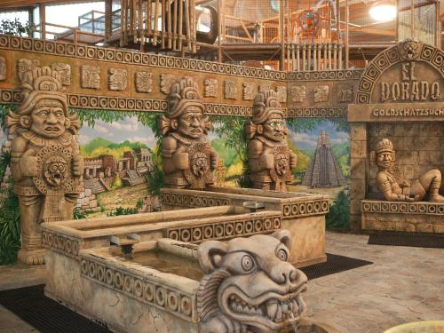 a room with a mural of statues on the wall at Appartements im Freizeitpark Weissenhäuser Strand in Weissenhäuser Strand