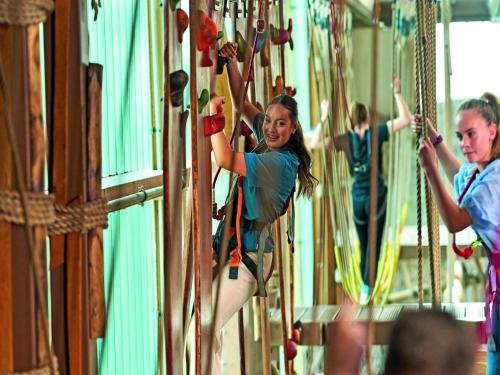 a group of people climbing on a ropes course at Appartements im Freizeitpark Weissenhäuser Strand in Weissenhäuser Strand