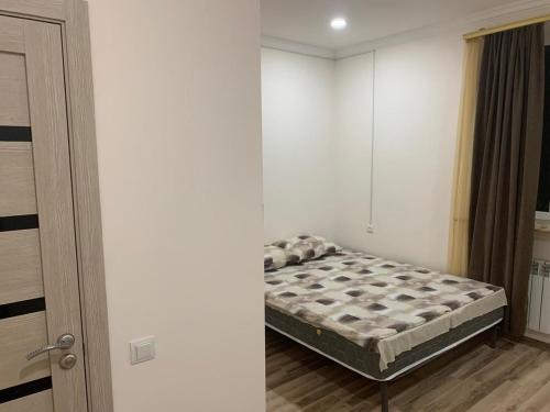 a bedroom with a bed in the corner of a room at Sevan-welcome in Sevan