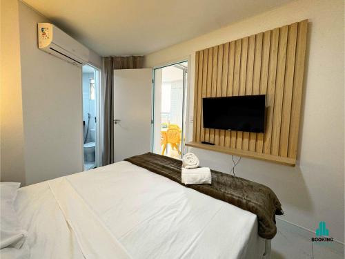 a hotel room with a bed and a flat screen tv at Aquarius Style by Holiday Stays in Fortaleza