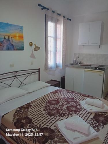 a bedroom with a bed and a kitchen in it at Giorgos House in Mythimna
