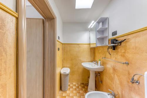 a bathroom with a sink and a toilet at la casa del sole in Leuca