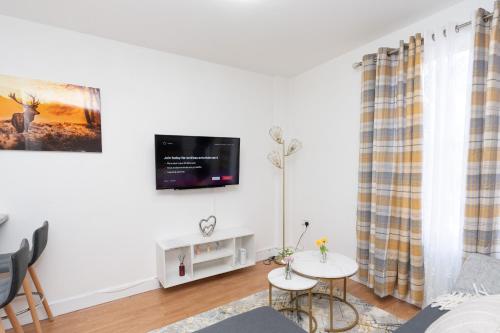 a living room with a tv on the wall at Permazing in Southampton