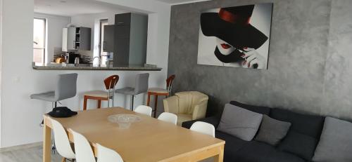 a living room with a table and a couch at Lux - Confort in Sînpetru
