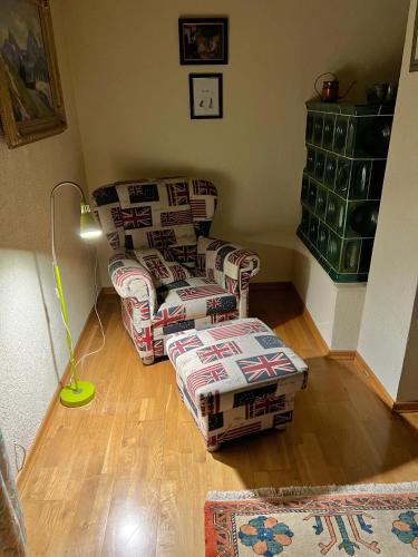 a living room with two couches and a lamp at Ferienhaus Faaker See 23 in Faak am See