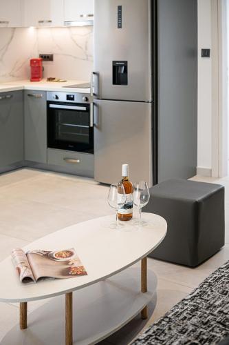 a kitchen with a white table and two wine glasses at Elio Apartment 1 in Chania Town