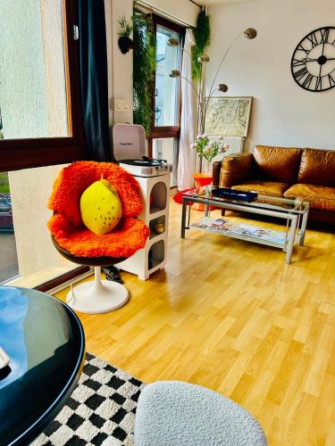 a living room with a couch and a chair at Le studio du Duc by Mathilde in Fécamp
